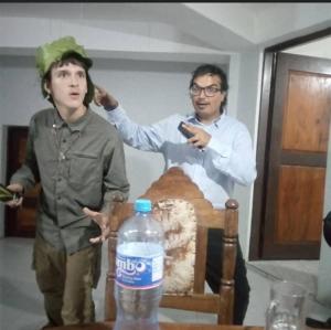 two men standing at a table with a bottle of water at Explore Rock city Mwanza in Mahango