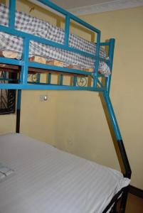 two bunk beds in a room with a white mattress at Explore Rock city Mwanza in Mahango