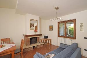 a living room with a blue couch and a fireplace at Villetta Gro - Gardagate in Sirmione +17 photos