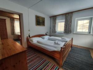 a bedroom with a bed in a room with windows at Stockerhütte - Ferienhaus in Vorderstoder