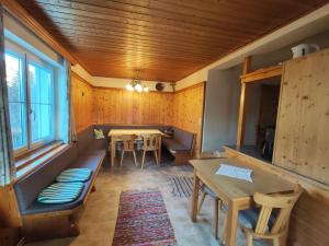 a room with a table and chairs and a dining room at Stockerhütte - Ferienhaus in Vorderstoder