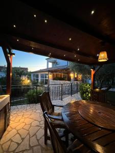 a wooden table and chairs on a patio at Villa Rossi in Krk