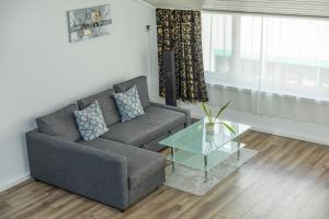 a living room with a couch and a glass table at Muota River Loft & Muota Industry Apartment near Stoos in Muotathal