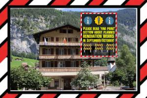 a picture of a building with a sign in front of it at Hotel Staubbach in Lauterbrunnen