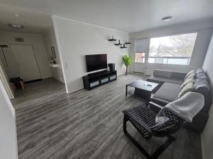 a living room with a couch and a tv at Lappi in Tornio