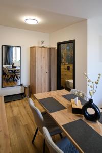 a dining room with a wooden table and chairs at U Šípků in Ostrava