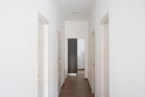 a hallway with white walls and wood floors at Il Sogno B&B Latronico Terme e Parco del Pollino in Latronico