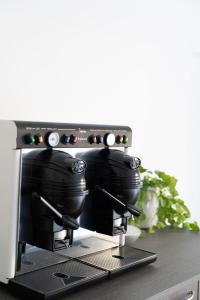 a coffee machine with pots and pans on a counter at Il Sogno B&B Latronico Terme e Parco del Pollino in Latronico +82 photos