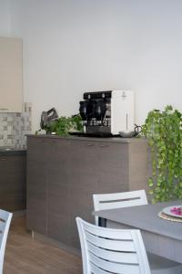 a kitchen with a counter with a table and chairs at Il Sogno B&B Latronico Terme e Parco del Pollino in Latronico