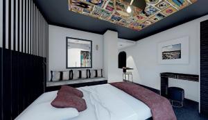 a bedroom with a large white bed with red pillows at Le VIBES RESORT By AGN "réservé aux couples" in Cap d'Agde