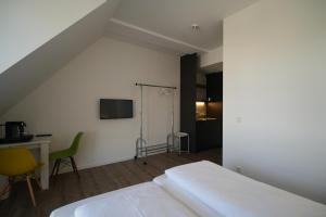 a bedroom with a bed and a desk and a chair at Printhouse in Münster