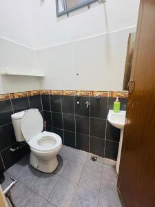 a bathroom with a toilet and a sink at Fath's Lodge in Dungun