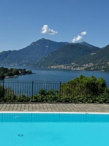 a swimming pool with a view of a lake and mountains at Casa Alba sul Lago in Dervio