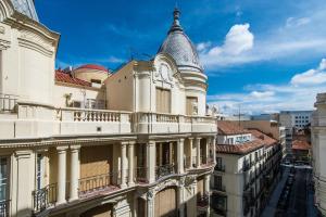 an old building with a turret on a city street at Vincci The Mint in Madrid