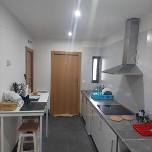 a kitchen with a sink and a wooden door at Linar Do Rei in Linares