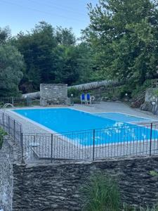a swimming pool with a fence around it at Casa Alba sul Lago in Dervio