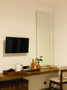 a kitchen with a counter with a television on a wall at The Heavens Villa - Colombo & BIA Airport in Ja-Ela
