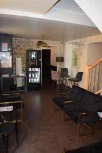 a living room with a couch and a table and chairs at Le lieu in Saint-Amour