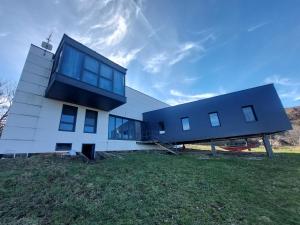 a house on top of a grassy field at Linar Do Rei in Linares
