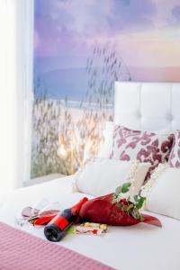 a bottle of wine laying on a bed at BestVillas Park Ofir in Esposende