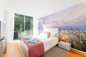 a bedroom with a bed and a large window at BestVillas Park Ofir in Esposende