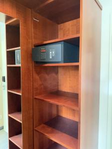 a book shelf with a microwave in a kitchen at Krone Langenburg by Ammesso in Langenburg +13 photos
