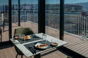 a table with two plates of food on a balcony at Lamal Hotel Napoli in Naples +56 photos