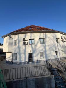 a large white building with windows and a fence at Ekoviki2 in Kranj