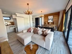 a living room with a white couch and a table at Chalet César in Risoul