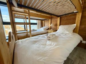 a bedroom with a large white bed and a window at Chalet César in Risoul