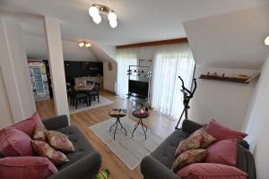 a living room with two couches and a television at Apartmani Lucija in Ludbreg