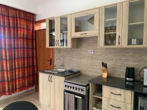 a kitchen with a sink and a stove at Kgcottage in Nairobi