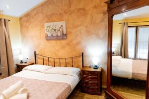 a bedroom with two beds and a mirror at Agriturismo la fornace in Como