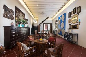 a restaurant with tables and chairs in a room at Muntri Mews in George Town