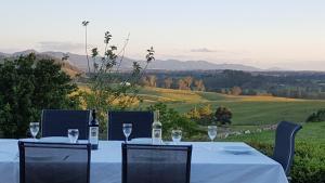 a table with two bottles of wine and glasses at Kia Ora Lookout Retreat in Gloucester