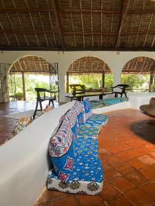 a group of pillows on a bed in a room at Sansuri Dreams Beach House in Msambweni