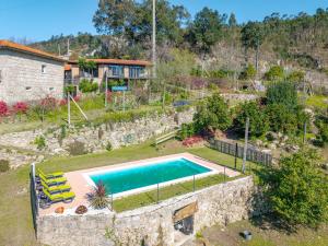 an external view of a house with a swimming pool at Casa da Portazinha - by Proguest in Amares