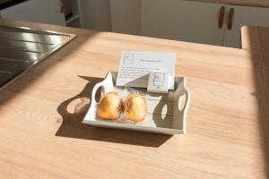 a table with a plate of rolls on a table at L'Embrun - Plage, port et marché à deux pas in Pornichet