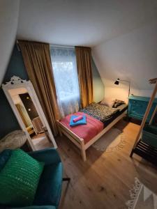 a small bedroom with a bed and a mirror at Richland Ráckeve in Ráckeve