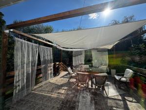 a patio with a table and chairs and a tent at Richland Ráckeve in Ráckeve