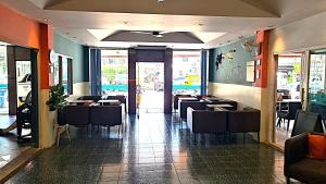a dining room with tables and chairs in a restaurant at Desa Phuket in Phuket