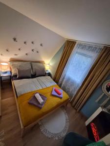 a bedroom with a bed with two towels and a window at Richland Ráckeve in Ráckeve +14 photos