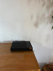 a black router sitting on top of a wooden table at Bella Vista Cabris in Cabris