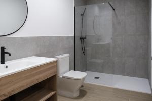 a bathroom with a shower and a toilet and a sink at Micampus Estanislao del Campo, Student Residence in Seville +13 photos