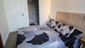 a bedroom with a bed with a bedspread with butterflies at Chambre chez l'habitant Res Belle Epoque Ville d'hiver in Arcachon +9 photos