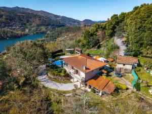 an aerial view of a house on a hill next to a river at Casa Sejões Gêres - by Proguest in Terras de Bouro