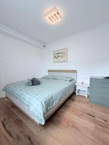 a bedroom with a bed with a cat laying on it at A & B apartment in Lovran