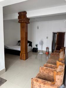 a room with three chairs and a bed at KmK Homestay in Rupa