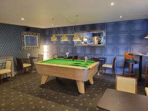 a room with a pool table in a restaurant at North Kessock Hotel in Inverness