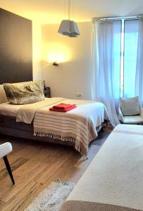a bedroom with a bed and a chair in it at Pension Villa Grün in Zwickau +14 photos